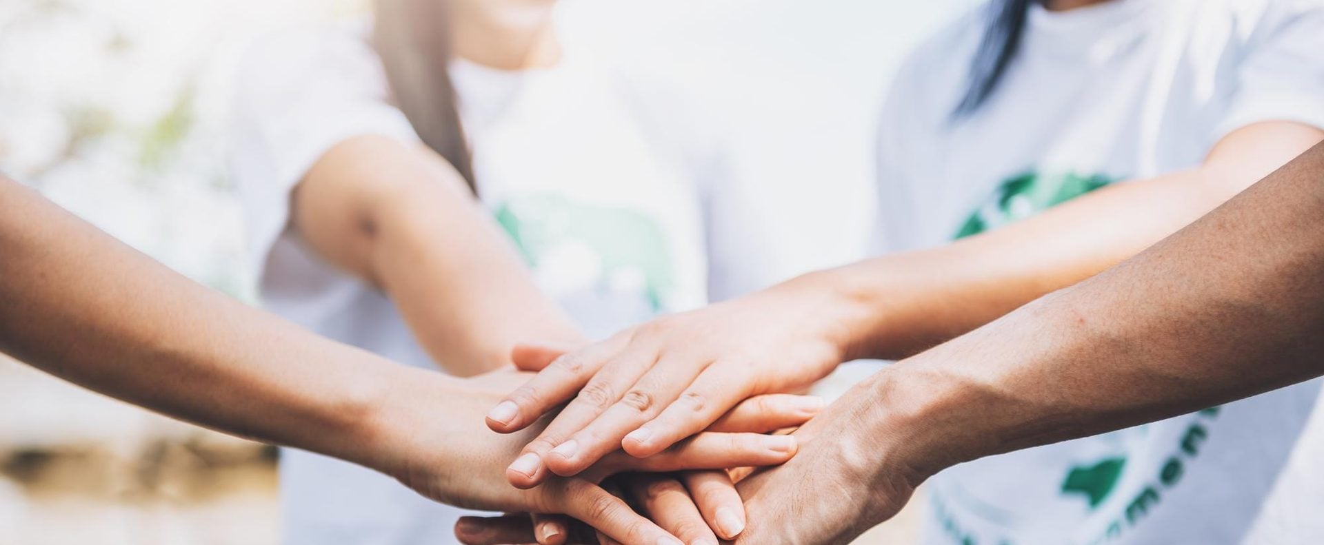 Volunteers’ hands joined together
